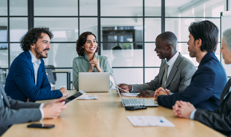 people sitting around a conference table talking